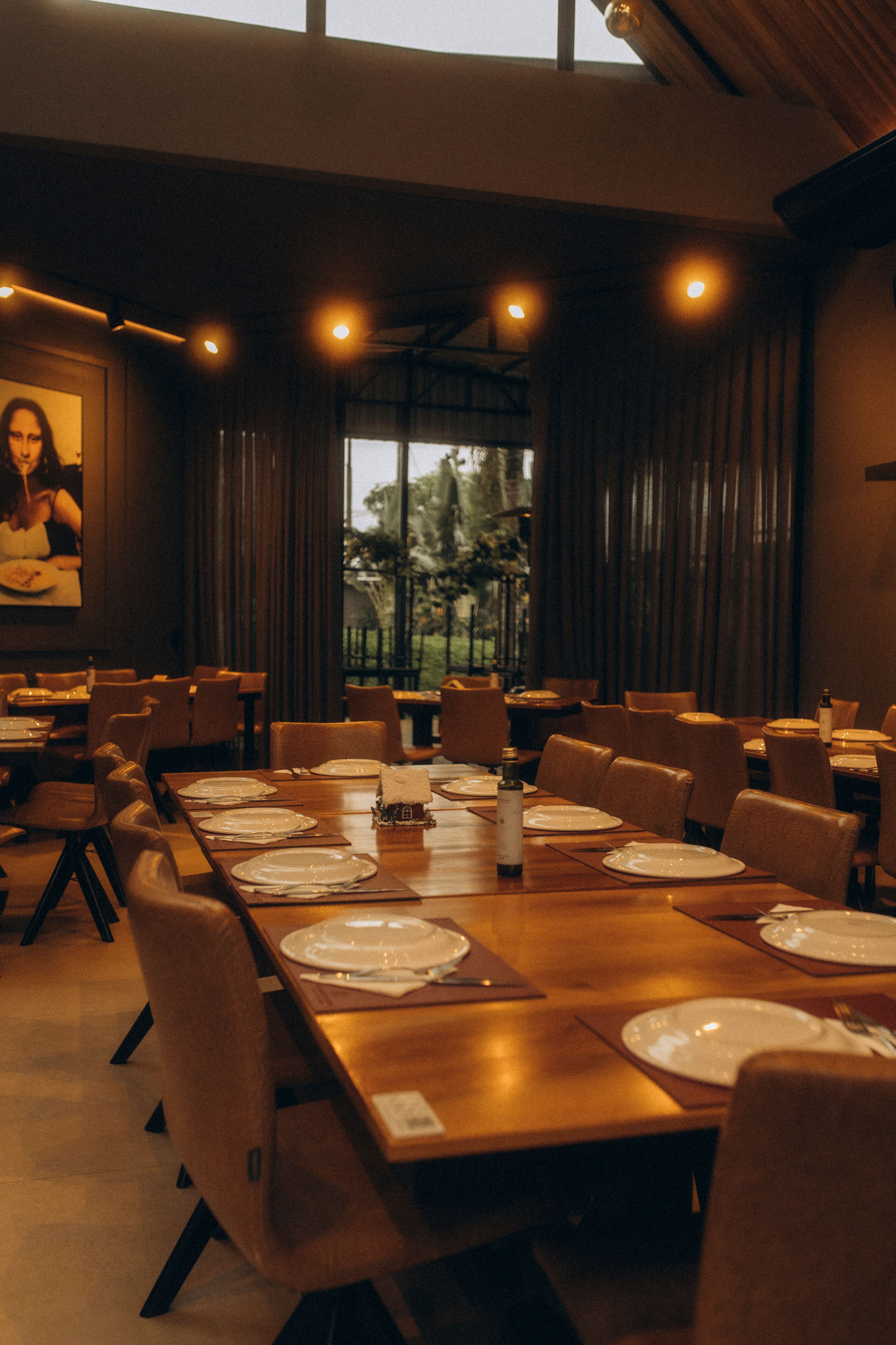 Set tables in a warmly lit dining room.